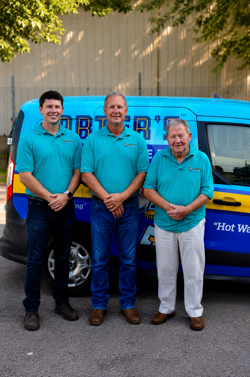 Three generations of the Carter family, owners of Carter's My Plumber, in front of a company van